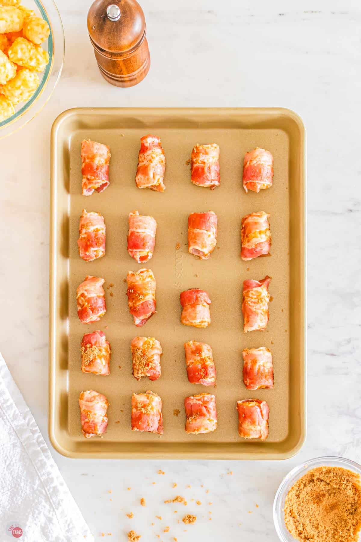 unbaked tater tots on a baking sheet