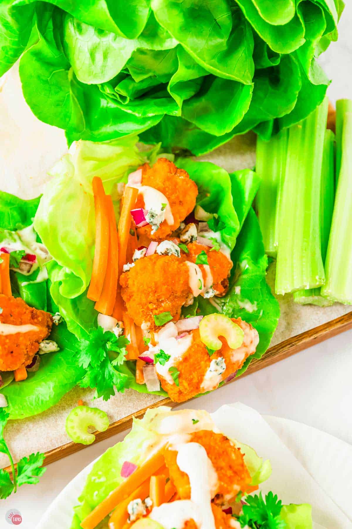 buffalo chicken lettuce wraps on a wood board