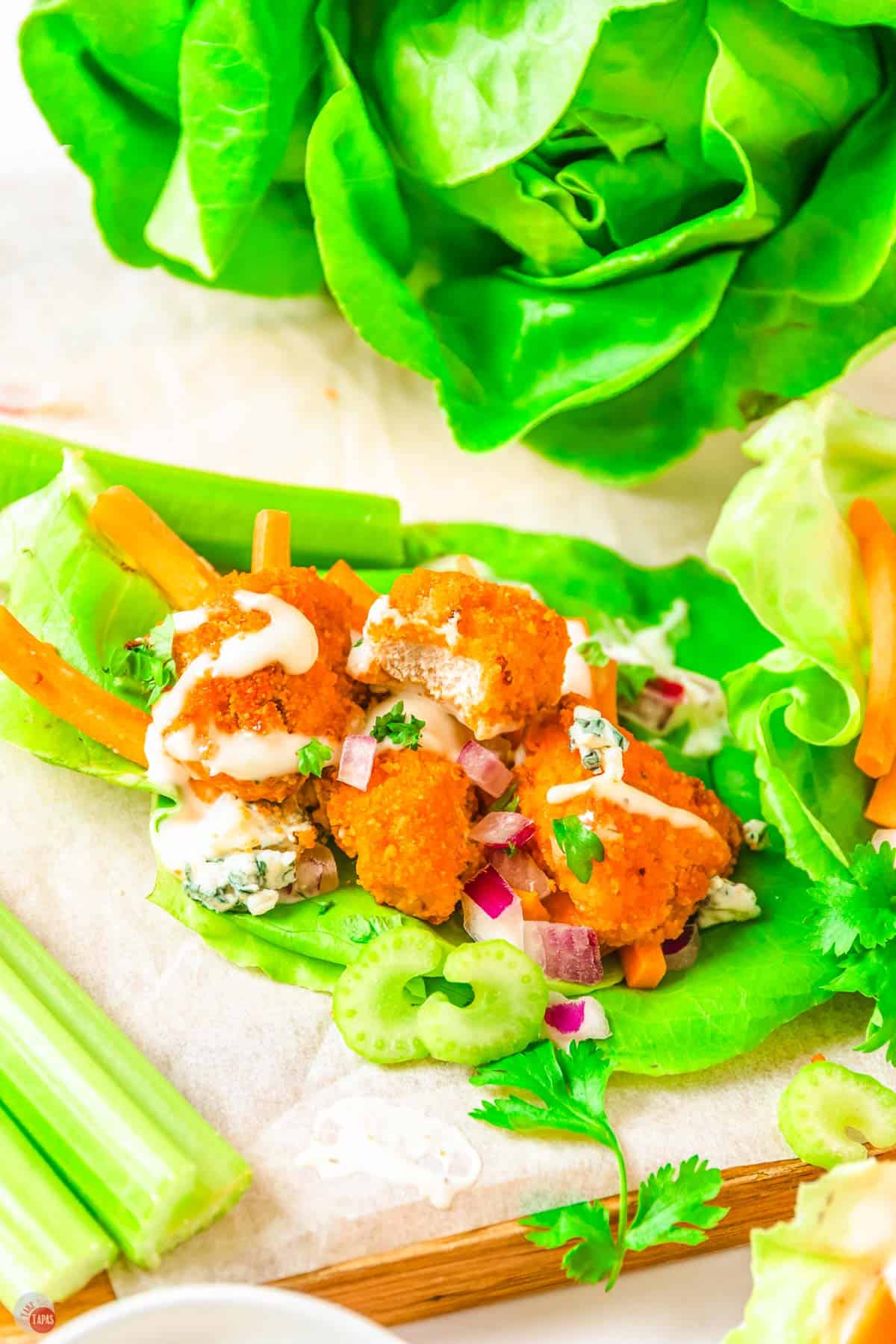 chicken and lettuce on a plate drizzled with ranch dressing