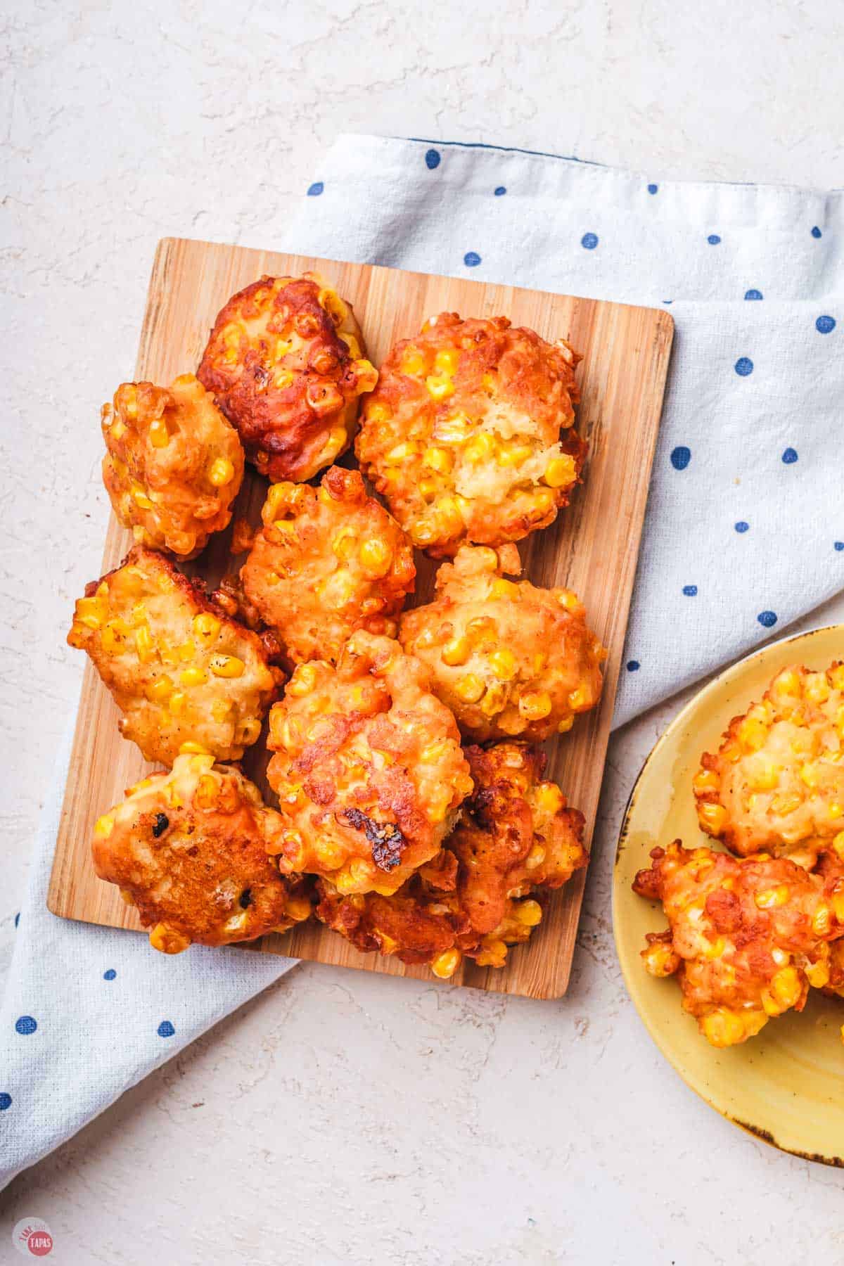 close up of corn nuggets on a white napkin with blue dots