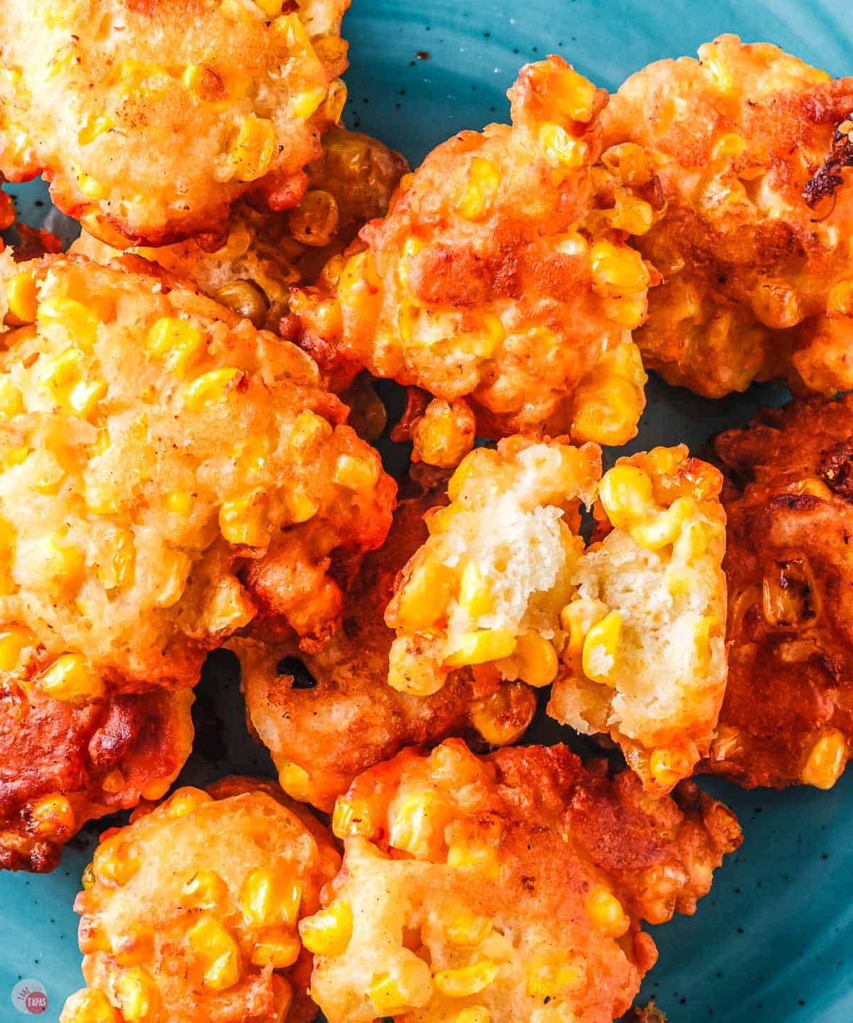 close up of corn nuggets on a blue plate