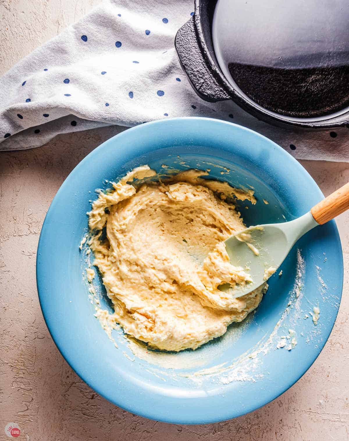 corn nugget batter in a blue bowl with a spatula