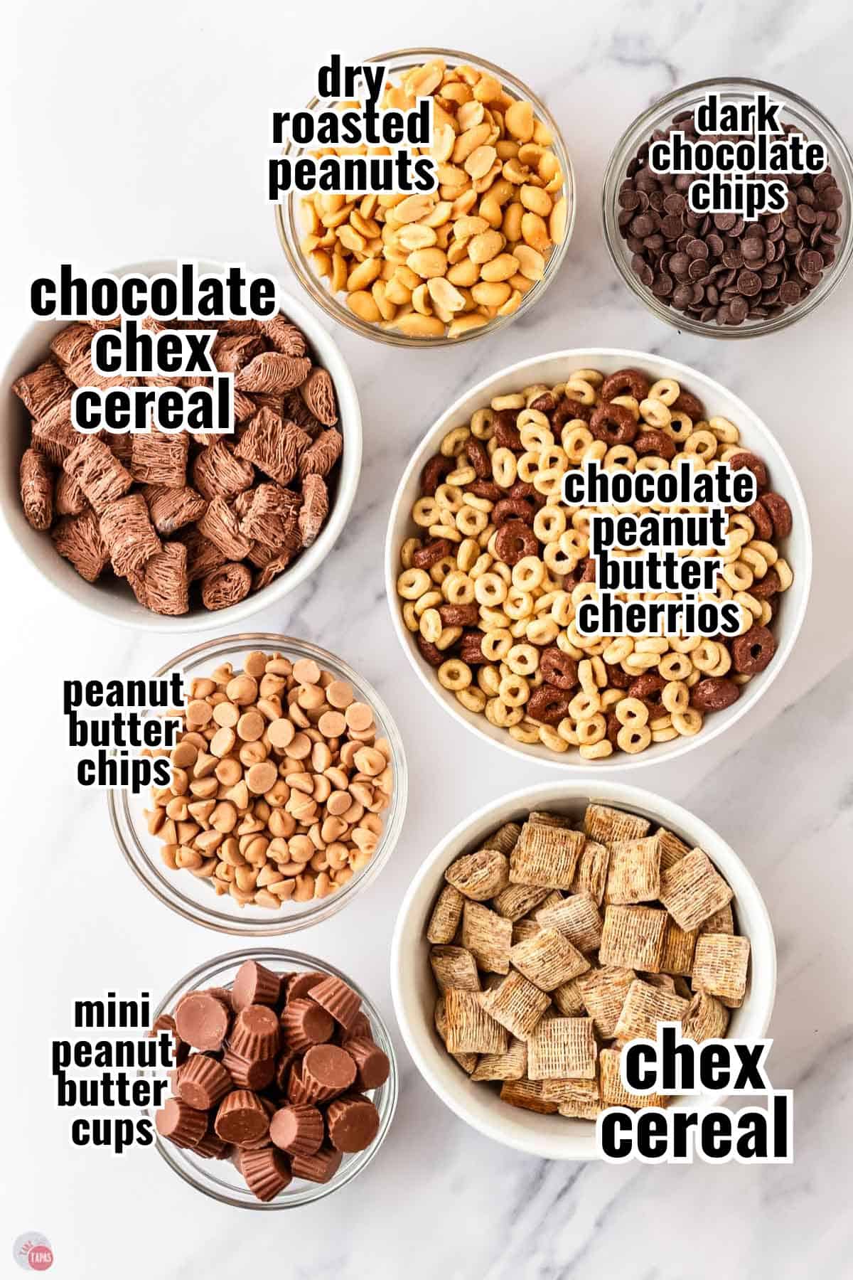 labeled ingredients for a snack mix in individual bowls