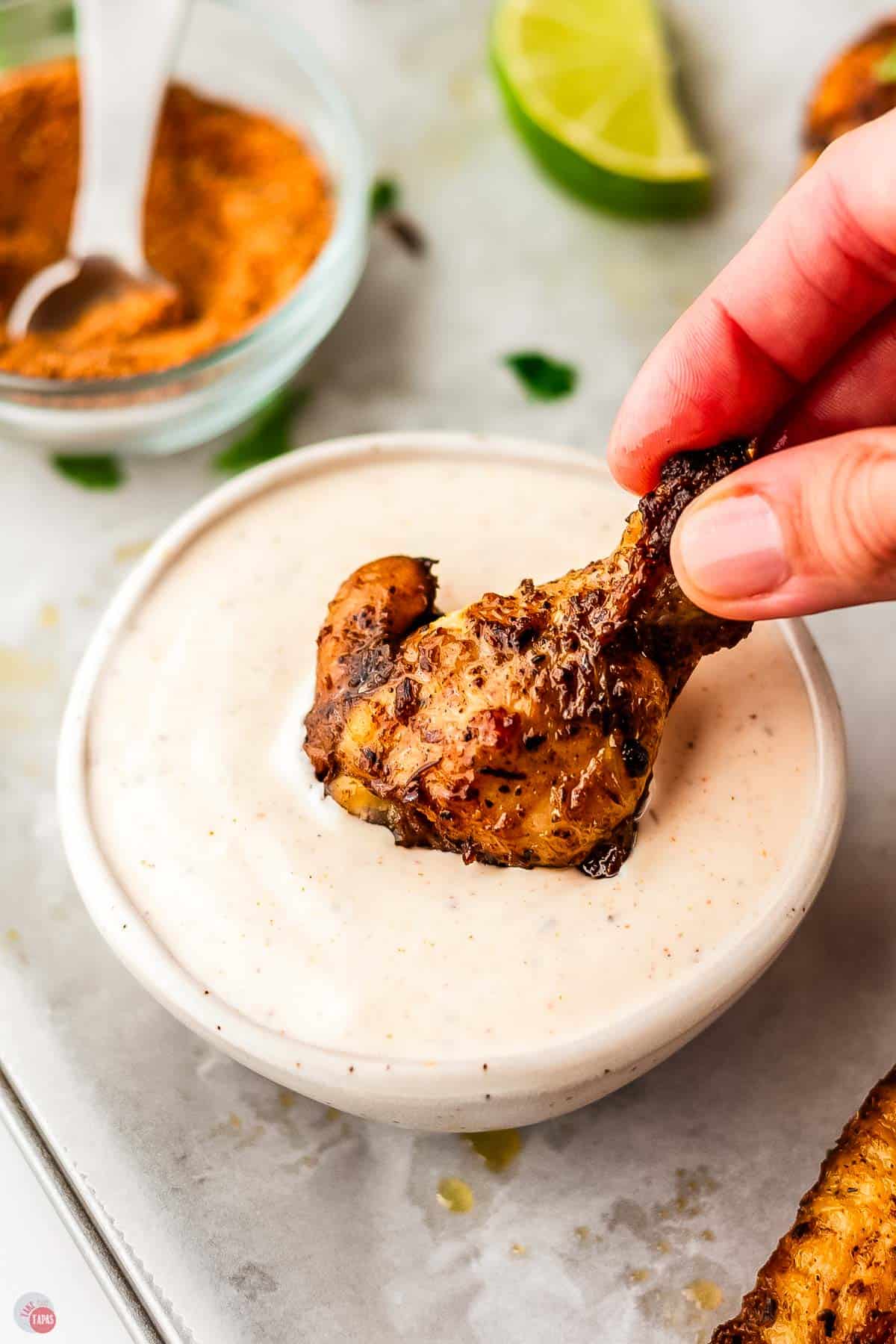 chicken drumstick dipping in sauce