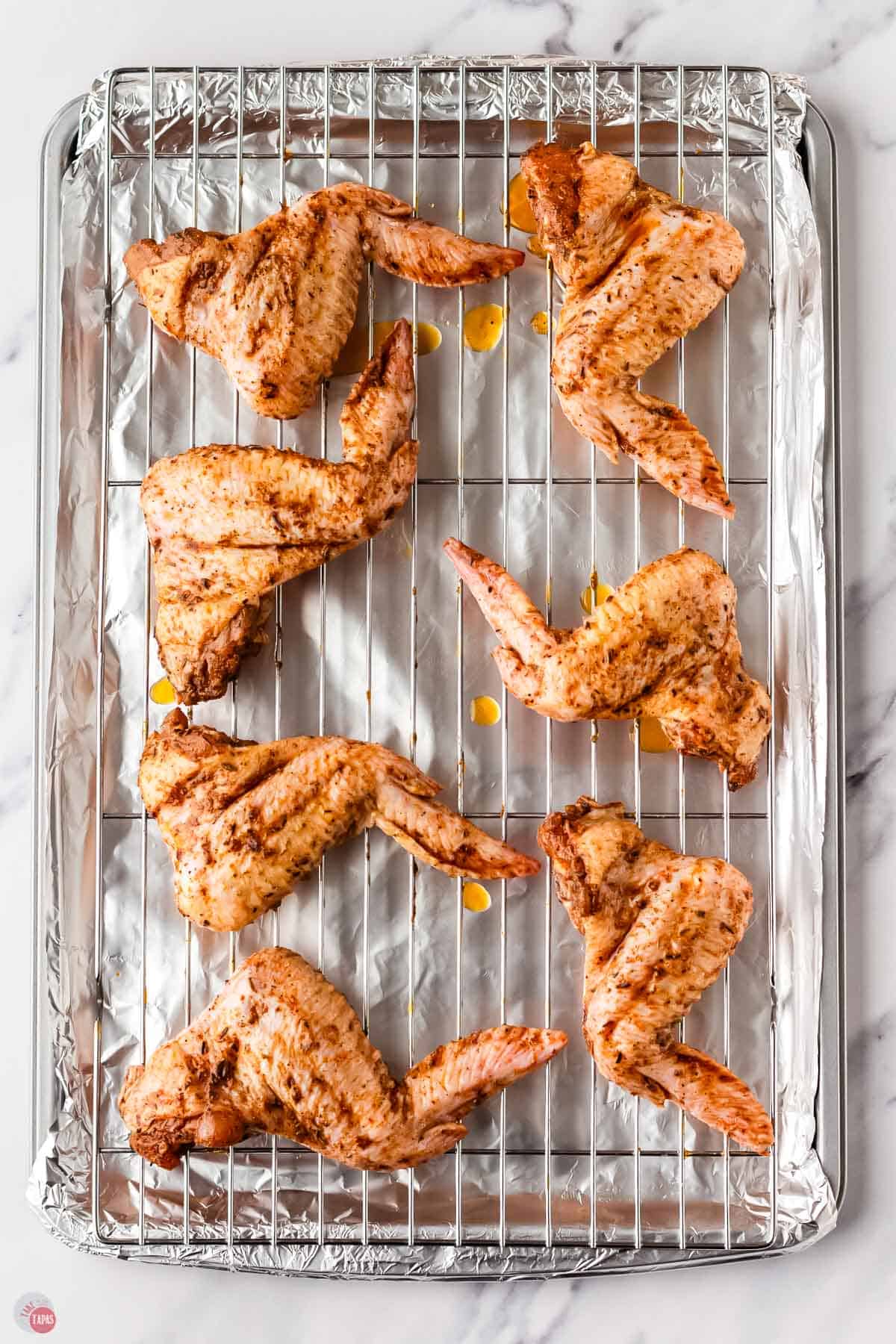 baking sheet with a wire rack on it and chicken wings