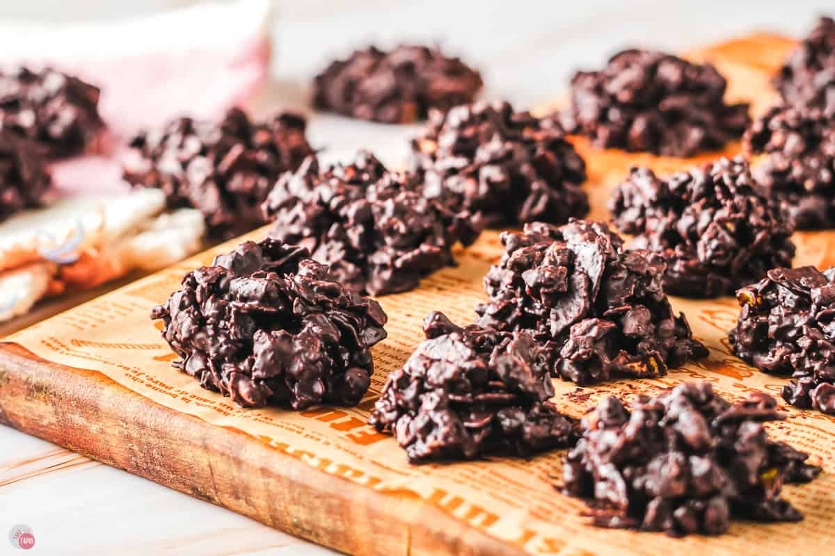 wood plank with snack clusters on it with parchment paper