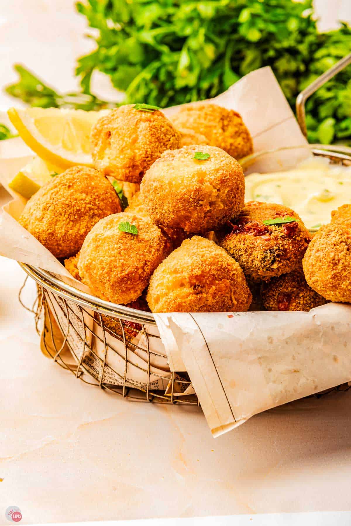 wire basket with a napkin and a stack of mushroom croquettes