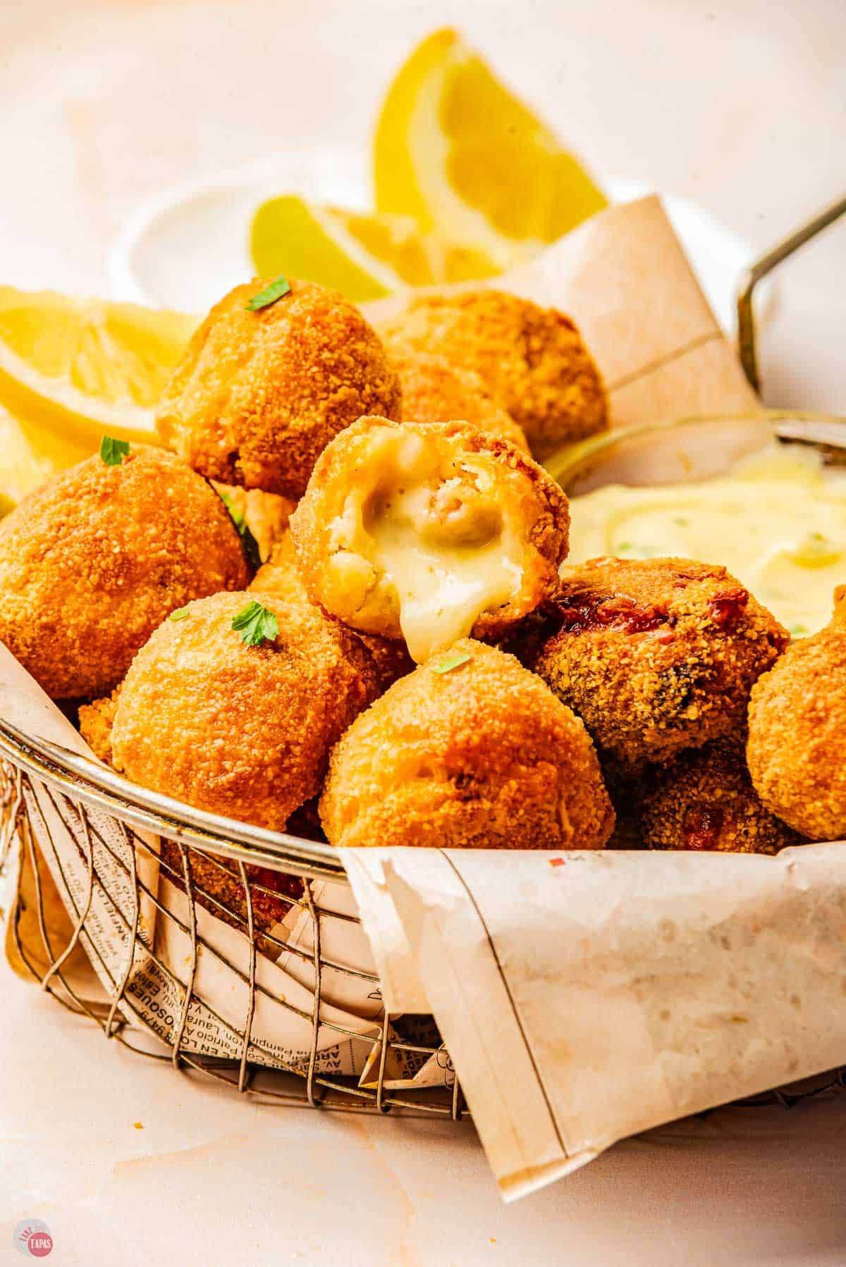 basket of mushroom croquettes with one open and cheese melting out