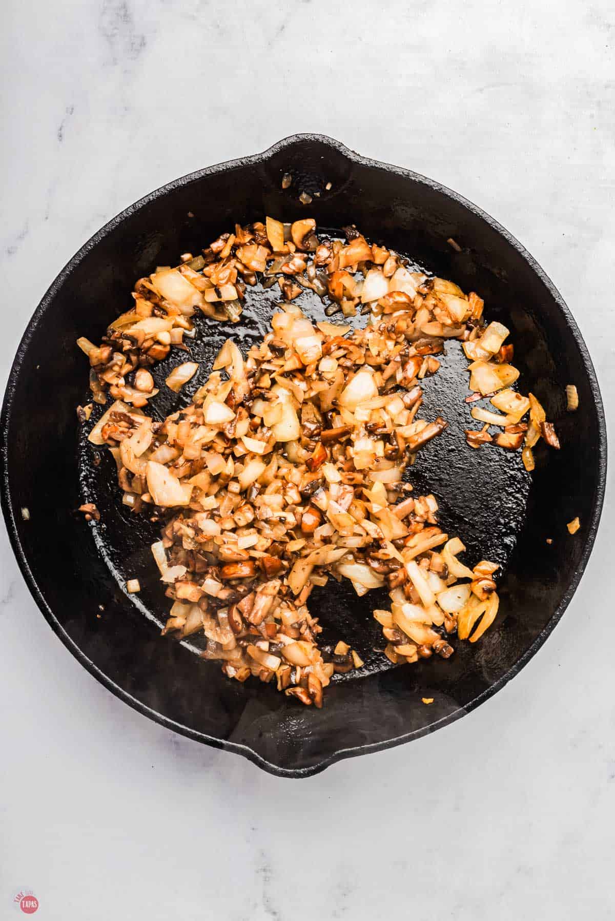 mushrooms and onions softened in a cast iron skillet