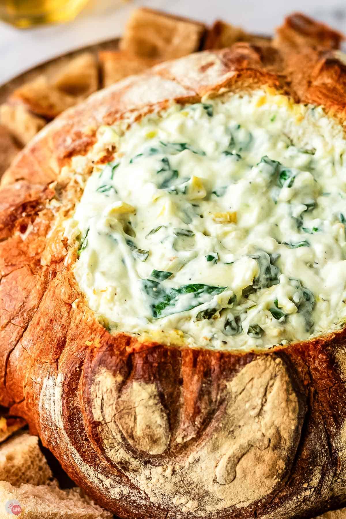 spinach artichoke dip baked in a bread loaf