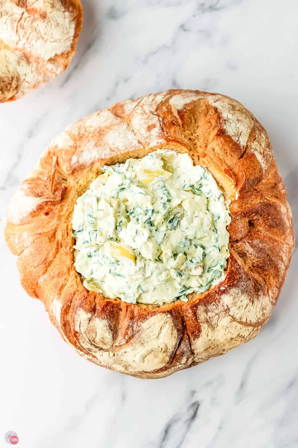 spinach artichoke dip in a bread bowl